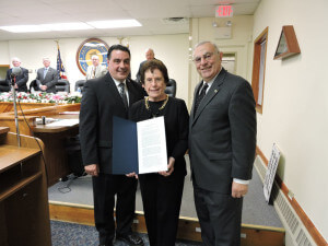 With the board of  commissioners and public offering a standing ovation, Aston Commissioners President Jim Stigale presented Neumann University President Dr. Rosalie Mirenda and her husband Tony, with a proclamation in recognition of the 50th anniversary of  the founding of the university.