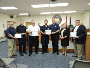 Aston Commissioner Carol Graham presented certificates of recognition to ATFD Chief Michael Evans, ATFD EMT Tony Cirino, CKHS Chief Paramedic Robert Reeder, ATFD EMT John Gibson Jr., ATFD EMS Captain Bruce Egan, and Aston Police Chief Dan Ruggieri. Photo by Loretta Rodgers